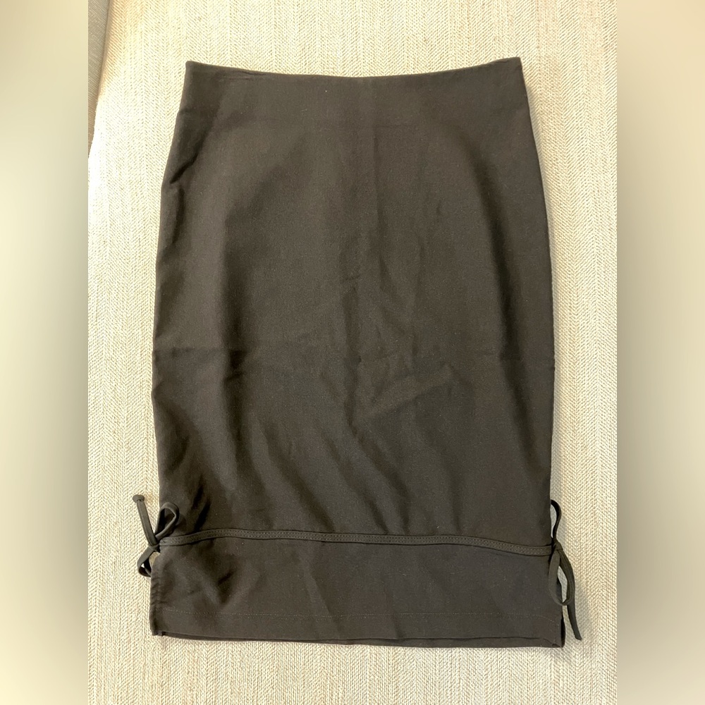 Juniors size 7/8 black stretchy pencil skirt with bow tie details at bottom hem